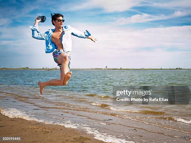 jumping on the beach - slippers stockfoto's en -beelden