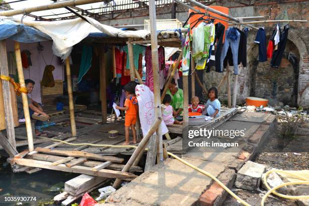 living in indonesia - jakarta slum stock pictures, royalty-free photos & images