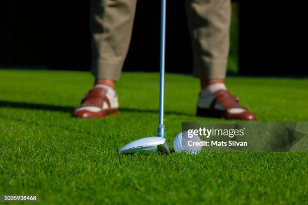 golfer with golf club fairway wood and golf ball - golf swing close up stock pictures, royalty-free photos & images