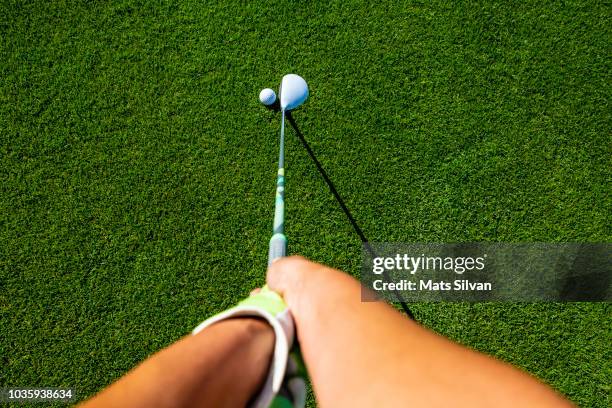 golfer with golf club fairway wood and golf ball - woman on swing foto e immagini stock