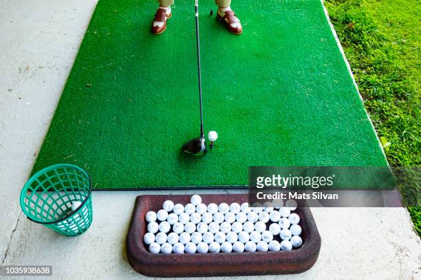golfer on golf driving range with driver golf club - driving range stock pictures, royalty-free photos & images