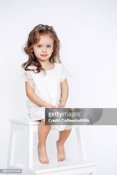 cute little girl in white dress smiling on camera - sweet little models stock pictures, royalty-free photos & images