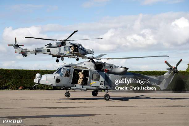 Prince Harry, Duke of Sussex arrives in an AH1 wildcat helicopter with the 847 naval air squadron as he visits The Royal Marines Commando Training...