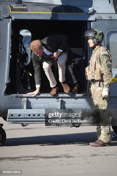 Prince Harry, Duke of Sussex arrives in an AH1 wildcat helicopter with the 847 naval air squadron as he visits The Royal Marines Commando Training...