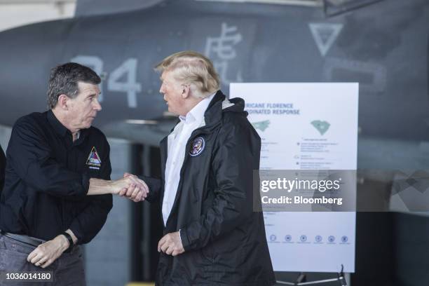 President Donald Trump shakes hands with Roy Cooper, governor of North Carolina, left, during a briefing at Marine Corps Air Station Cherry Point in...