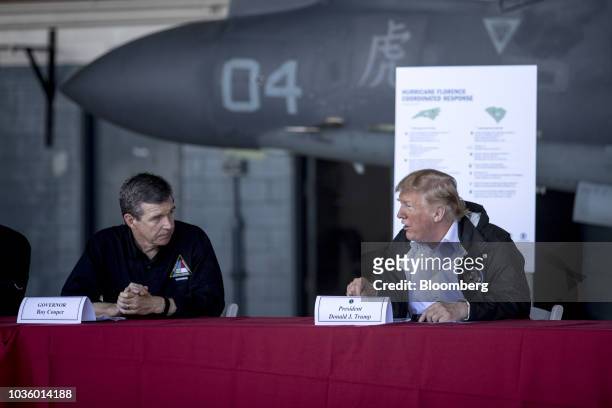 President Donald Trump speaks as Roy Cooper, governor of North Carolina, left, listenS during a briefing at Marine Corps Air Station Cherry Point in...