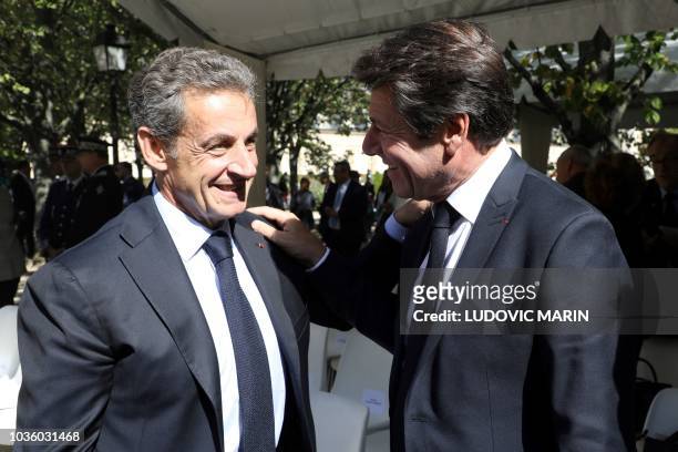 Former French President Nicolas Sarkozy talks with the Mayor of Nice Christian Estrosi during the national ceremony in memory of the victims of...
