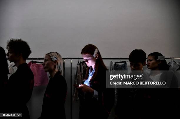 Models wait to be dressed backstage before presenting creations by Annakiki during the Women's Spring/Summer 2019 fashion shows in Milan, on...