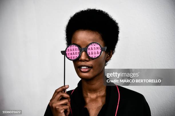 Model jokes backstage before presenting creations by Annakiki during the Women's Spring/Summer 2019 fashion shows in Milan, on September 19, 2018.