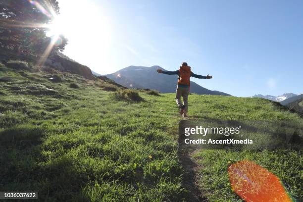 man walks along pathway in celebratory mood - andorra stock pictures, royalty-free photos & images