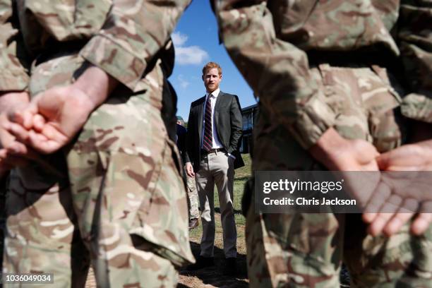 Prince Harry, Duke of Sussex talks to Commandos by the assault course as he visits The Royal Marines Commando Training Centre on September 13, 2018...