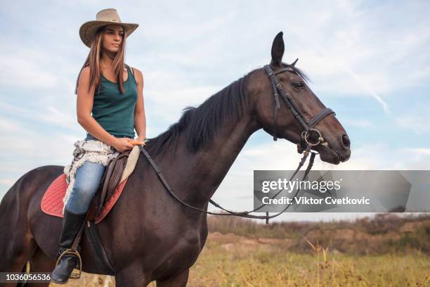 horseback riding home on the range - beautiful cowgirls stock pictures, royalty-free photos & images
