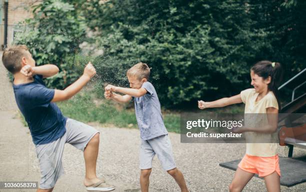 preparing for water balloon battle - kids fashion show stock pictures, royalty-free photos & images