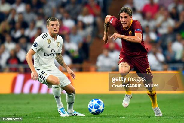 Roma's Italian midfielder Nicolo Zaniolo vies with Real Madrid's German midfielder Toni Kroos during the UEFA Champions League group G football match...