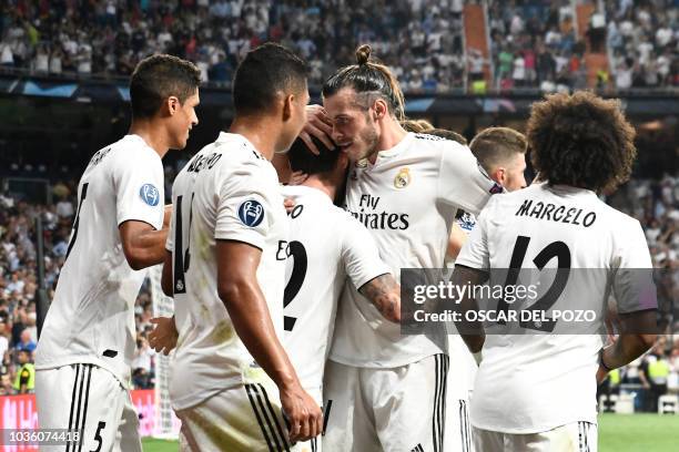 Real Madrid's Welsh forward Gareth Bale congratulates Real Madrid's Spanish midfielder Isco for scoring their team's opening goal during the UEFA...