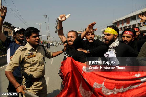 Police detains mourners during a Muharram procession at Batamaloo area on September 19, 2018 in Srinagar, India.