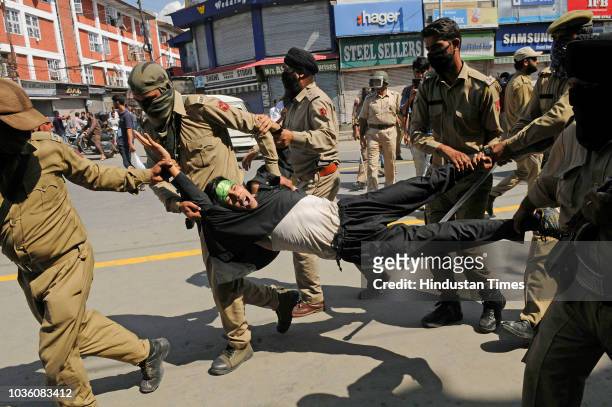 Police detains mourners during a Muharram procession at Lal chowk area on September 19, 2018 in Srinagar, India.