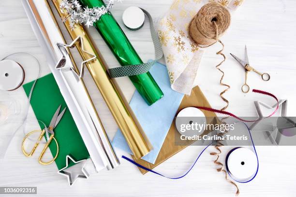 christmas gift wrapping materials on a white table - roll of wrapping paper stock pictures, royalty-free photos & images