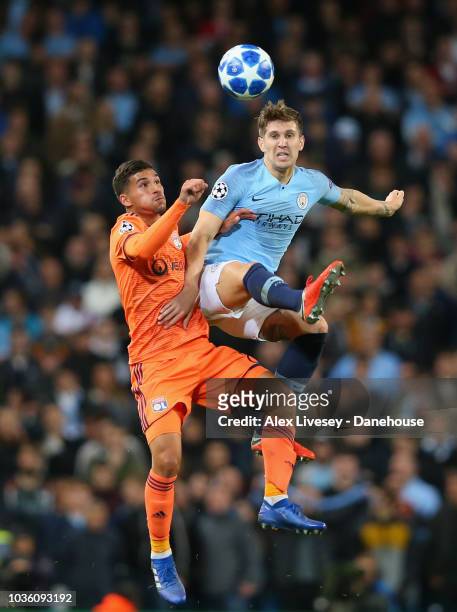 John Stones of Manchester City competes for the ball with Houssem Aouar of Olympique Lyonnais during the Group F match of the UEFA Champions League...