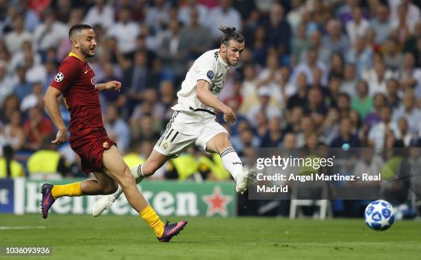 Gareth Bale of Real Madrid scores his team's second goal during the Group G match of the UEFA Champions League between Real Madrid and AS Roma at...