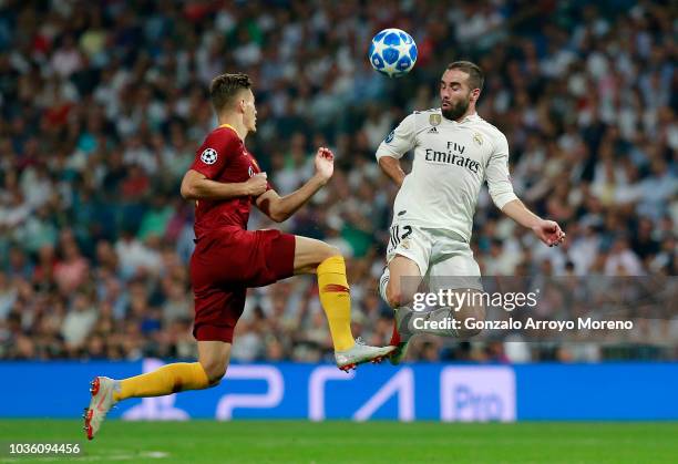 Patrik Schick of AS Roma battles for possession with Daniel Carvajal of Real Madrid during the Group G match of the UEFA Champions League between...