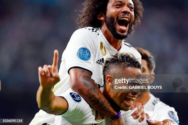 Real Madrid's Spanish-Dominican forward Mariano celebrates his goal with Real Madrid's Brazilian defender Marcelo during the UEFA Champions League...