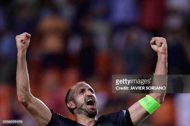 Juventus' Italian defender Giorgio Chiellini celebrates at the end of the UEFA Champions League group H football match between Valencia CF and...