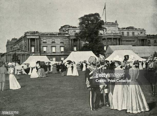 Her Majesty's Garden Party: Indian Visitors', . Guests on the lawn outside Buckingham Palace in London. From Sixty Years A Queen: The Story of Her...