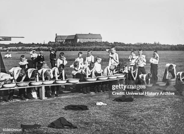 Magic lantern slide circa 1900.Victorian.Social History. Orphans in a field washing in tin wash basins,