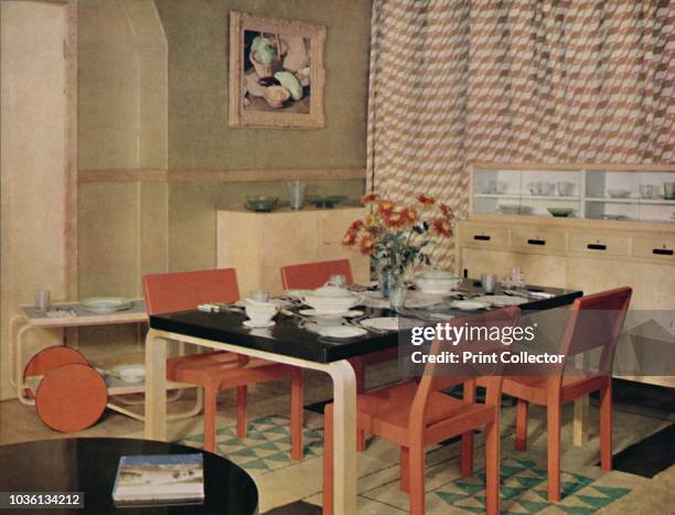 Dining Room with Finnish furniture'', 1938. Arranged by Finmar Ltd, furniture designed by Alvar Aalto, made of cellulosed birch. Table legs and...