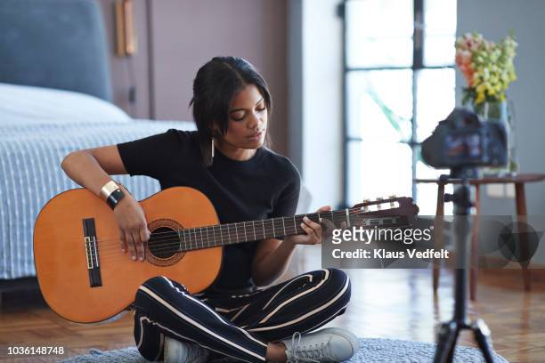 female influencer recording for video blog with guitar lesson - musician stock pictures, royalty-free photos & images