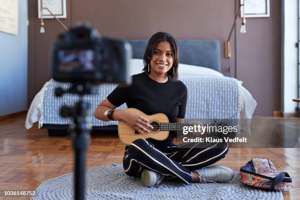 female influencer recording for video blog with ukulele lesson - ukulele stock-fotos und bilder