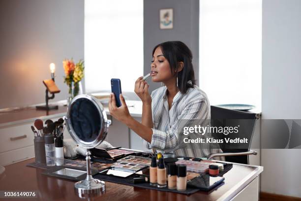 female influencer recording make-up tip videos using smartphone, for her blog - only women videos stock pictures, royalty-free photos & images