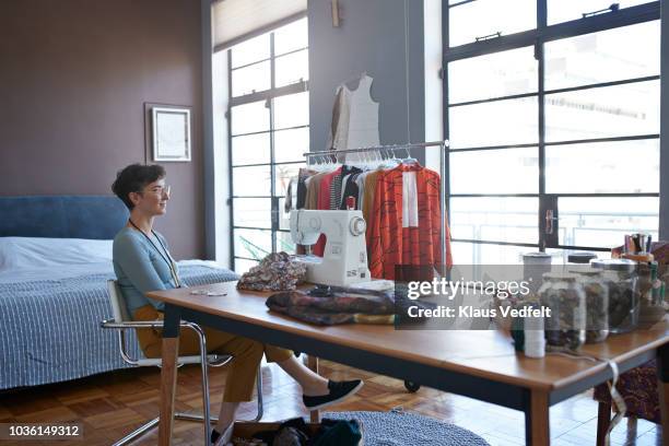 portrait of female clothing designer working from home - tailor pants stock pictures, royalty-free photos & images