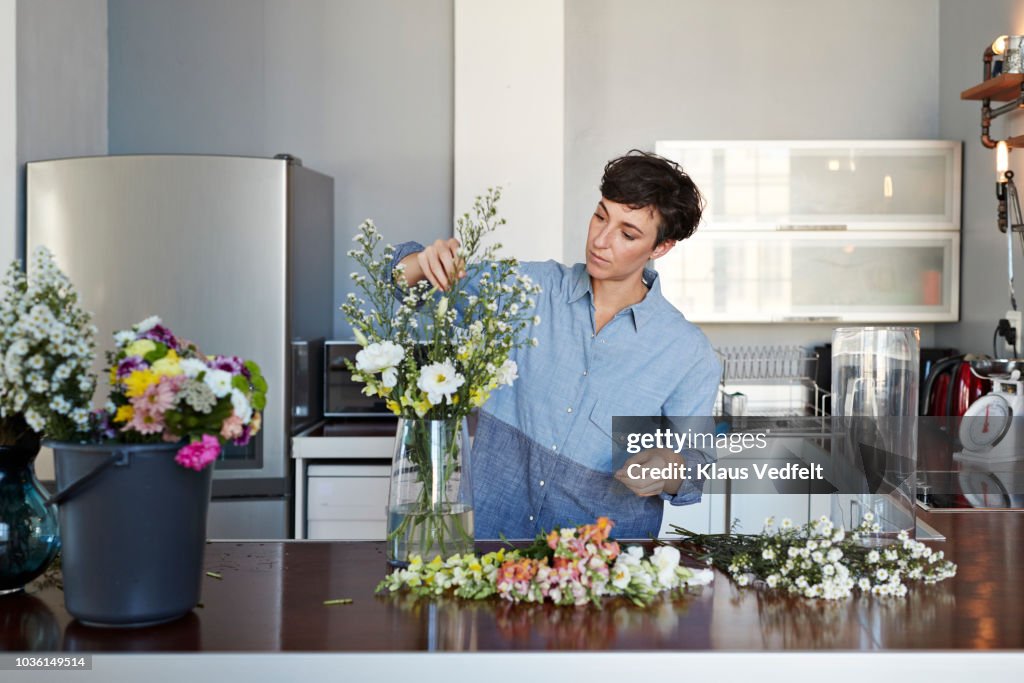 Female florist organising flowers for customer from home