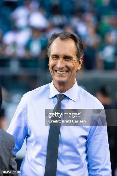 Sports commentator Cris Collinsworth walks on the field before the game between the Philadelphia Eagles and the Atlanta Falcons at Lincoln Financial...