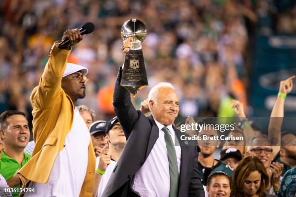 Philadelphia Eagles owner Jeffrey Lurie hoists the Vince Lombardi Trophy with hall of famer Brian Dawkins before the game against the Atlanta Falcons...