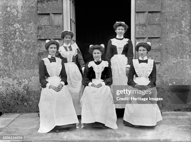 Servants at Biddlesden Park House, Buckinghamshire, c1896-c1920. A rare view of five female house servants next to a doorway. Artist Alfred Newton &...