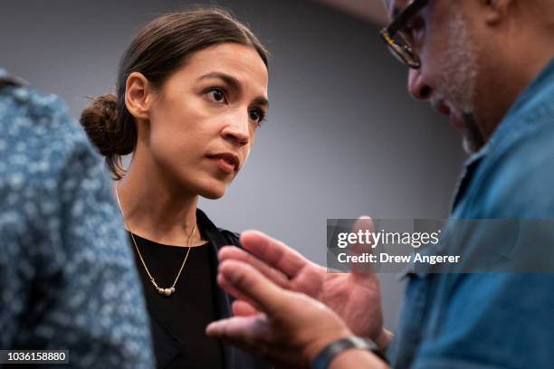 Alexandria Ocasio-Cortez, Democratic candidate running for New York's 14th Congressional district, talks with a voter at the conclusion of a town...