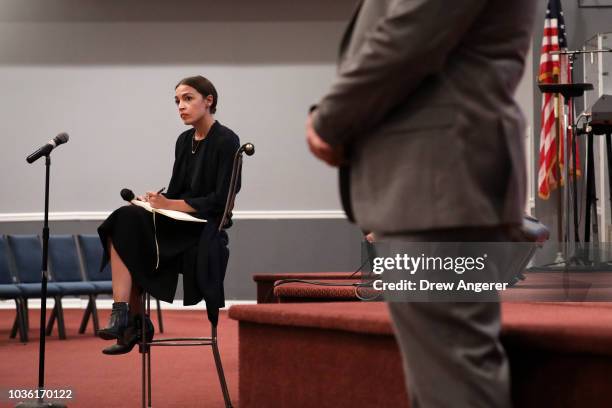 Alexandria Ocasio-Cortez, Democratic candidate running for New York's 14th Congressional district, takes questions at a town hall event, September...