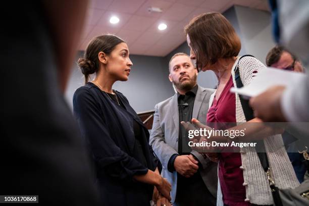 Alexandria Ocasio-Cortez, Democratic candidate running for New York's 14th Congressional district, talks with a voter at the conclusion of a town...