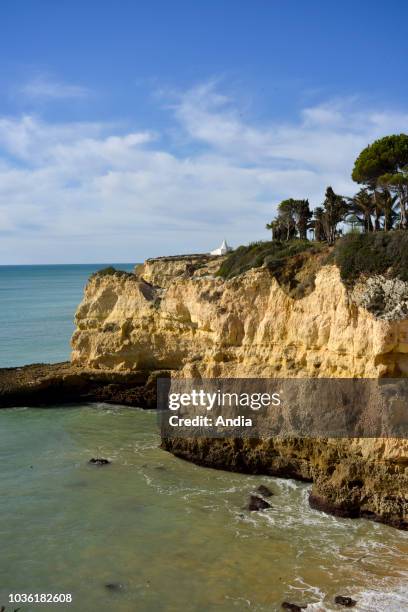 Portugal, region of the Algarve, Armacao de Pera: Chapel of Nossa Senhora da Rocha , white chapel atop the cliff