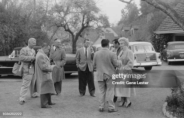 American actress Marilyn Monroe with photographers and reporters outside her home during a photo call, California, USA, 1956.