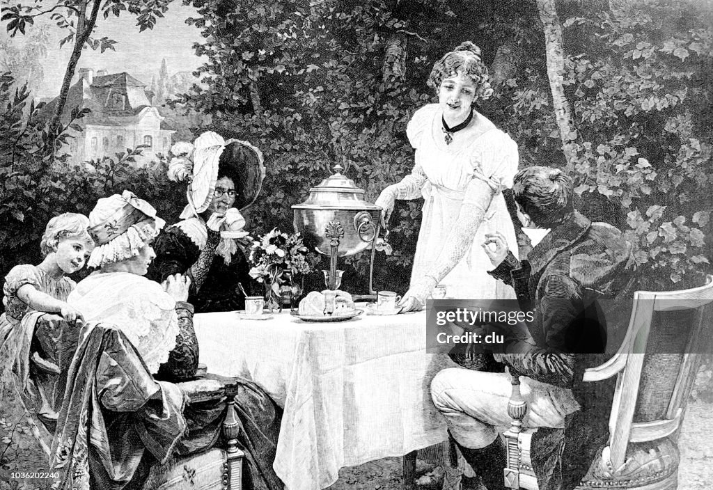Family outdoor in the garden drinking coffee or tea