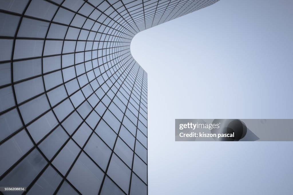 Reflection on office building glass windows with curve lines.