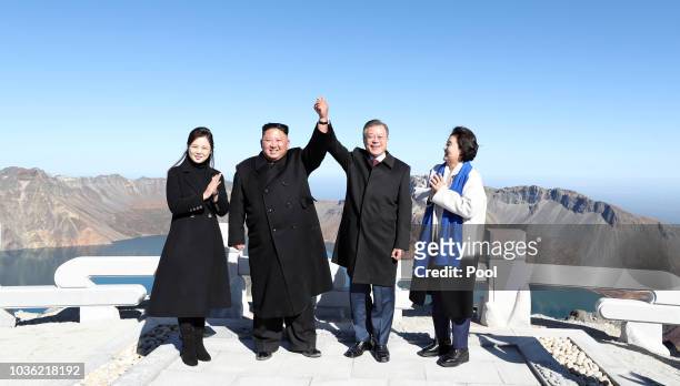 North Korean leader Kim Jong Un and his wife Ri Sol Ju pose with South Korean President Moon Jae-in and his wife Kim Jung-sook on the top of Mount...