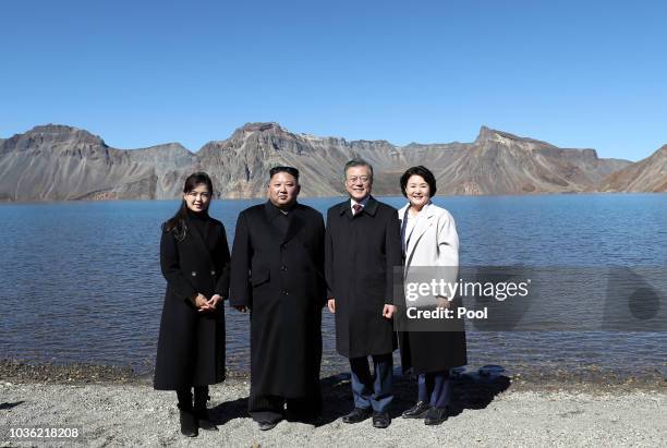 North Korean leader Kim Jong Un and his wife Ri Sol Ju pose with South Korean President Moon Jae-in and his wife Kim Jung-sook on the top of Mount...