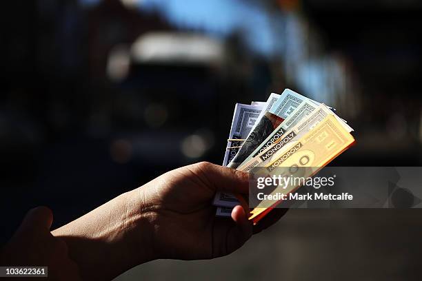 Monopoly promotions staff hand out Monopoly notes to Sydneysiders on Oxford Street during Monopoly's 75th anniversary celebration on August 25, 2010...