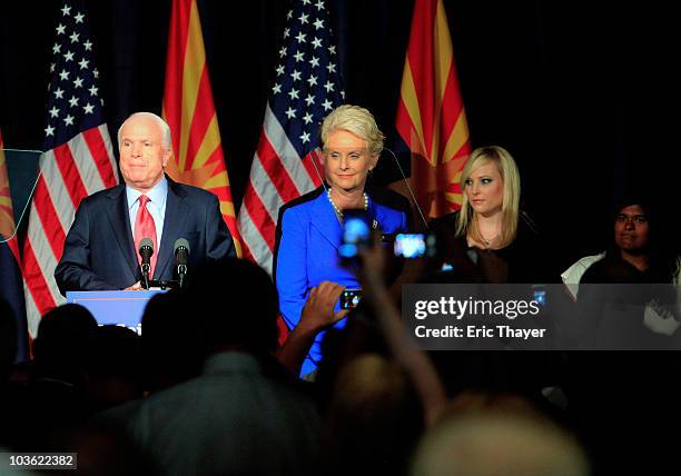 Sen. John McCain speaks to a group of supporters alongside his wife Cindy and daughters Meghan McCain and Bridget McCain at his victory party after...