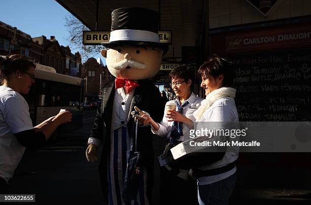 Monopoly promotions staff hand out Monopoly notes to Sydneysiders on Oxford Street during Monopoly's 75th anniversary celebration on August 25, 2010...
